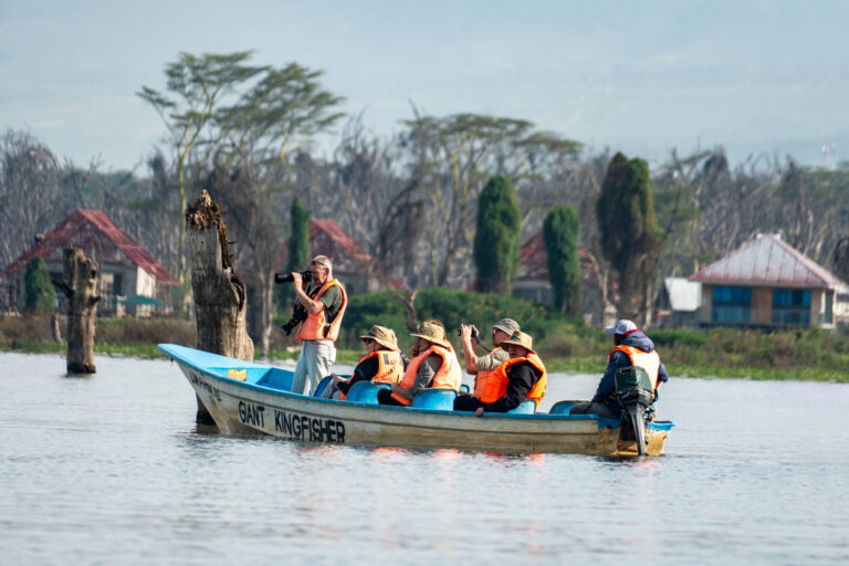 tourists sail by boat on lake naivasha. water safari with viewing of animals and birds